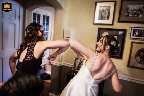   At a private residence in Saratoga, California, heartfelt getting ready moments capture the anticipation and excitement shared with an elbow bump before the ceremony.